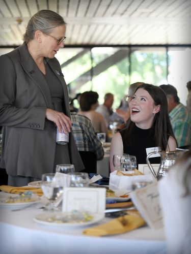 米博体育 President Dr. Kelly Ryan speaking with a student. 